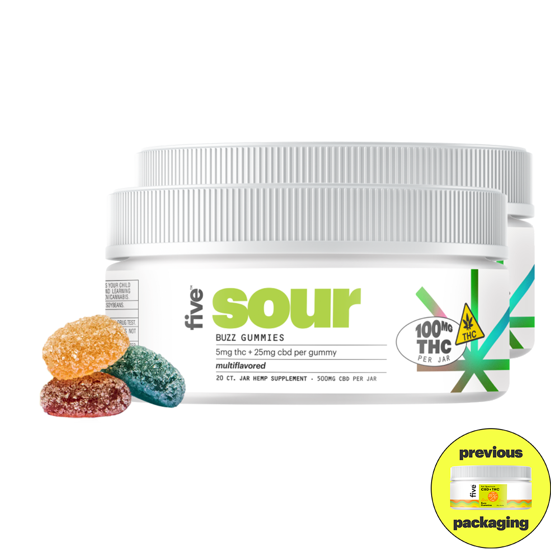Two white jars of Five Sour Buzz Gummies with gray lids, accompanied by three sugar-coated gummies in orange, blue, and red. The label reads: 'five sour BUZZ GUMMIES 5mg thc + 25mg cbd per gummy multiflavored 20 CT. JAR HEMP SUPPLEMENT 500MG CBD PER JAR 100MG THC PER JAR THC'.