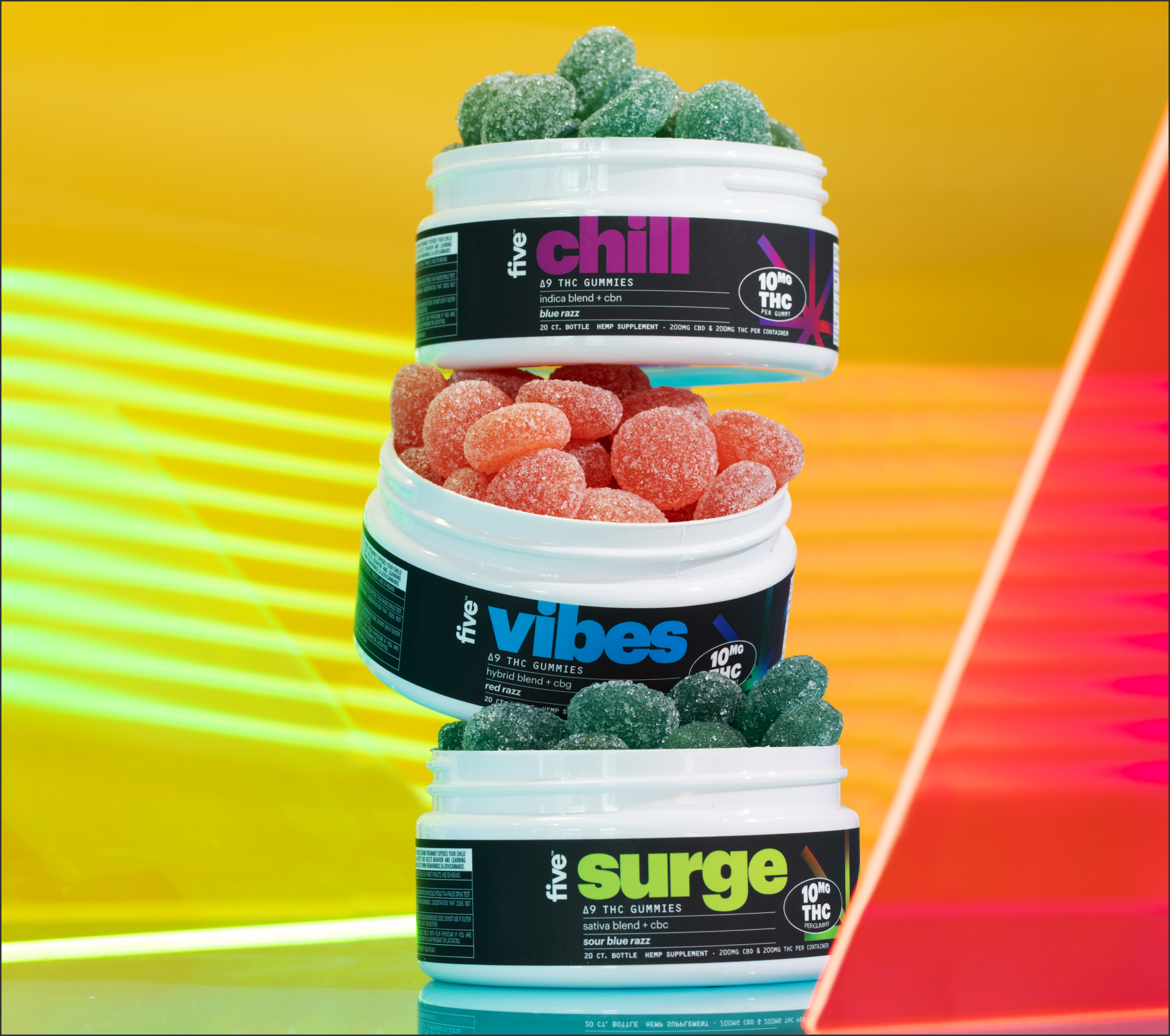 Stacked gummy tubs labeled five chill, five vibes, five surge; sugar-coated gummies and 10MG THC label visible.