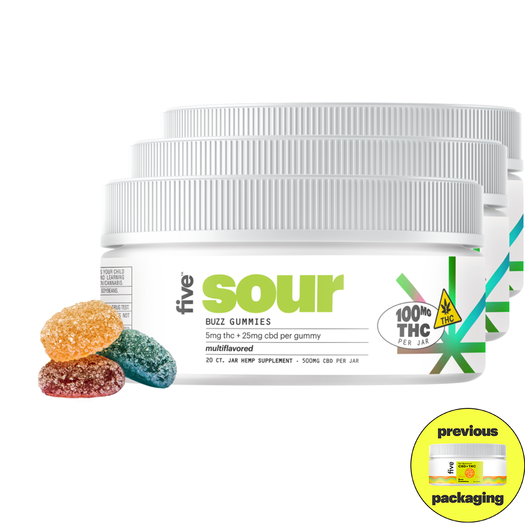 Five Buzz Gummies sour flavor jar with 100mg THC per jar label and three sugar-coated gummies in orange, red, and blue colors in front.