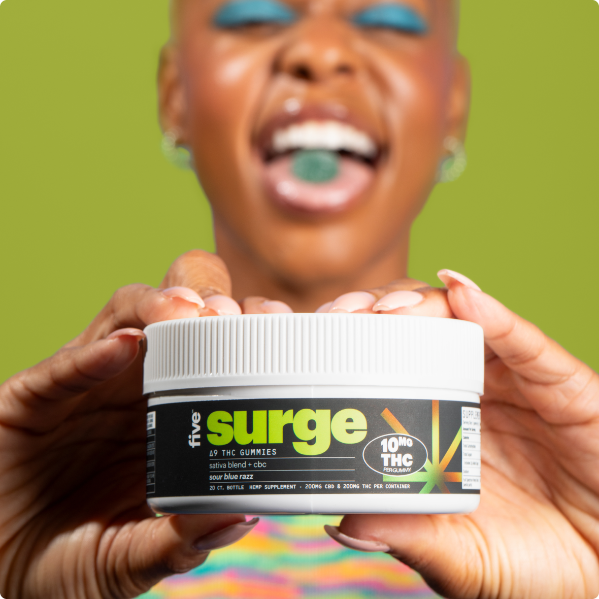 Smiling person holds a jar labeled surge; visible text on jar: sativa blend + cbc; 10MG THC